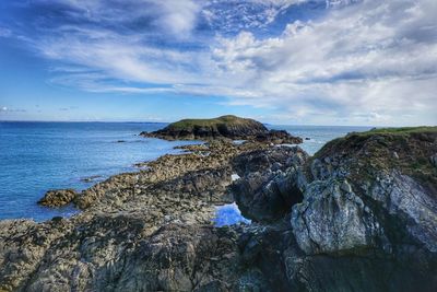 Scenic view of sea against cloudy sky