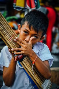 Portrait of boy holding camera