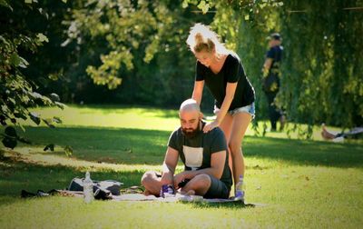 Woman sitting on bench in park