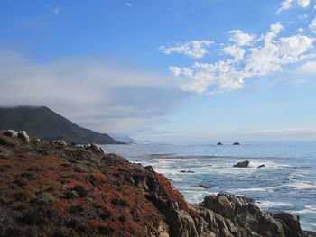 Scenic view of sea against cloudy sky