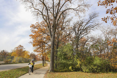 Man walking on footpath during autumn