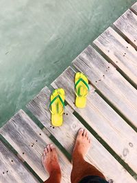 Low section of man standing on pier