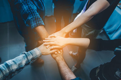 Midsection of people holding hands