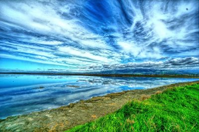 Scenic view of sea against cloudy sky