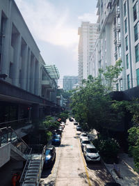 Street amidst buildings in city against sky
