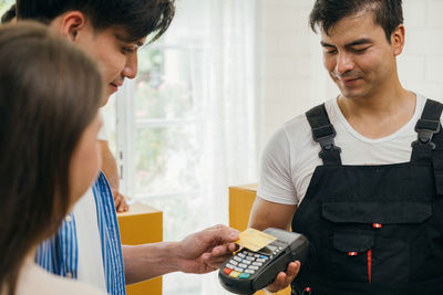 Side view of young man working at home