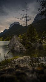 Scenic view of river and mountains against sky