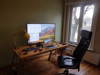 Electric lamp on table by window at home