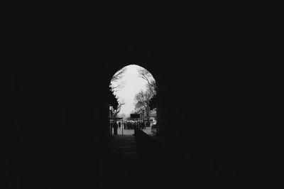 Illuminated tunnel at night