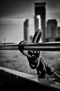 Close-up of rope on railing against sky