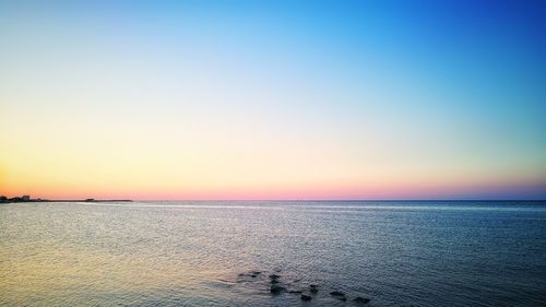 Scenic view of sea against clear sky during sunset