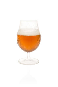 Close-up of beer glass against white background