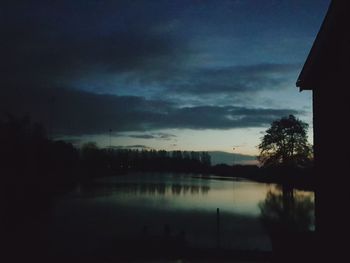 Scenic view of lake against sky at night