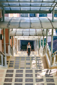 Portrait of woman standing against ceiling