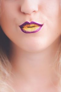 Cropped image of woman with purple lipstick