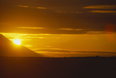 Scenic view of silhouette mountains against sky during sunset