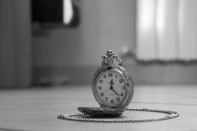 Close-up of clock on table