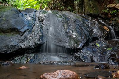 Water flowing through rocks in forest