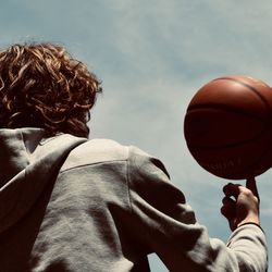 Rear view of man playing basketball