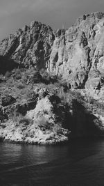 Scenic view of rock formation in sea against sky