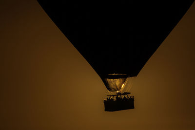 Low angle view of silhouette hot air balloon in clear sky during sunset