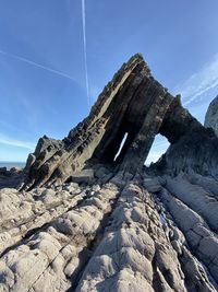 Low angle view of rock formation against sky