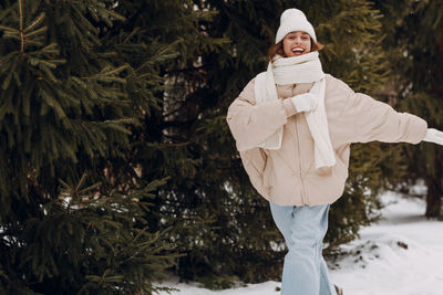 Low section of woman standing on tree