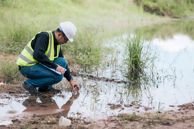 Rear view of man working at beach