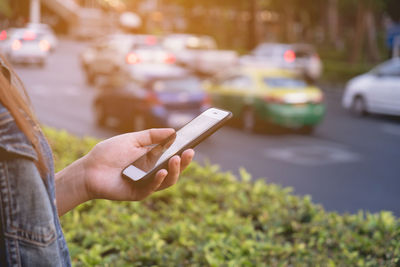 Midsection of man using mobile phone