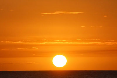 Scenic view of sea against orange sky