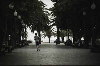 Man walking on zebra crossing in city