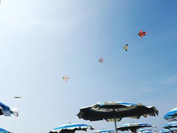 Low angle view of kite flying against clear blue sky