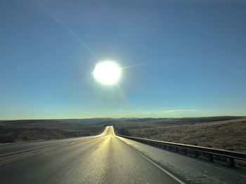 Country road against sky