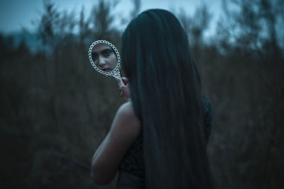 Side view of woman standing at night