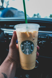 Close-up of hand holding coffee cup