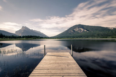 Pier over lake against sky