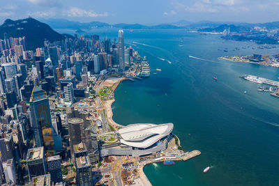 High angle view of city by sea against sky