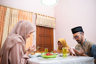 Family praying together at home during ramadan