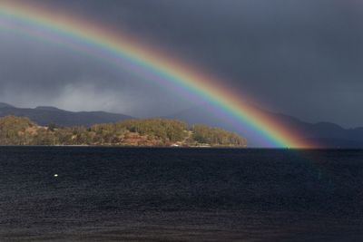 Rainbow over mountain against sky