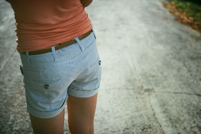 Midsection of woman standing on road