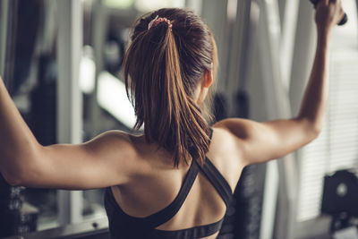 Young woman exercising in gym