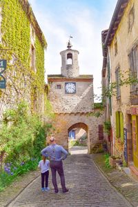 Full length of woman standing on footpath