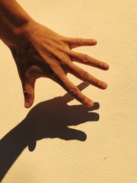 Close-up of hand touching wall