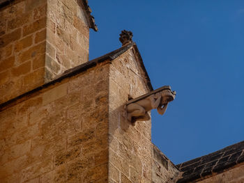 Low angle view of statue against blue sky