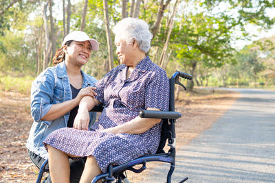 Woman sitting on swing at park