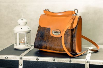 Close-up of electric lamp on table against wall