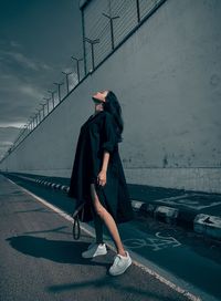 Side view of woman walking on street