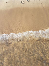 High angle view of waves on beach