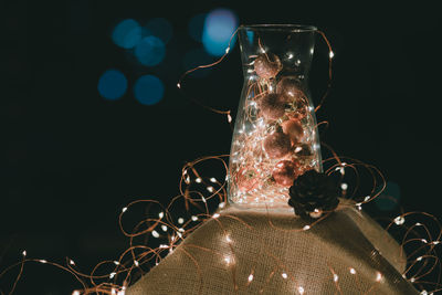 Close-up of decorations with illuminated christmas lights