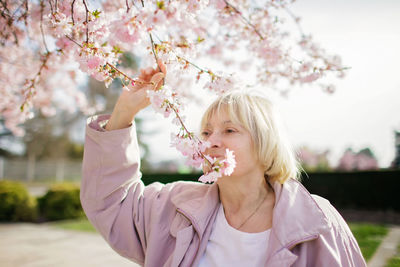 Portrait of woman near blowing flowers